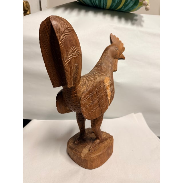 Carved from a single block of wood, this chicken has lots of detail. Look at the spurs on his legs. He is quite heavy.