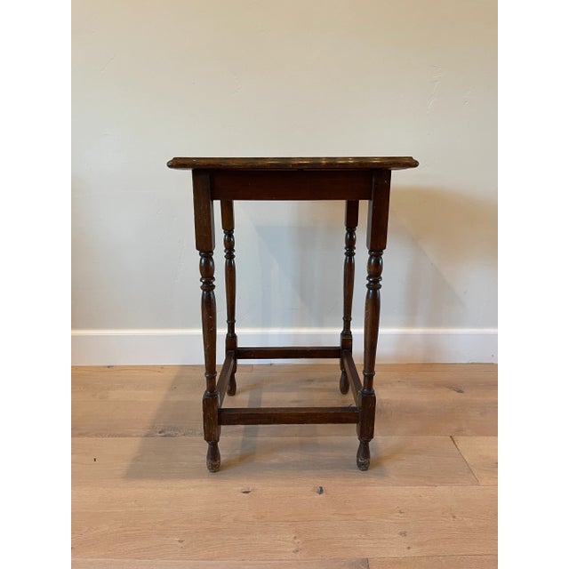 The Vintage Dark Wood Side table features a dark wood stain, turned wood legs and a planked top. Simple yet stately, this...