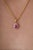 This pendant showcases a 0.7 carat ruby set in 14k yellow gold. The ruby measuring 4.2 x 6.2 mm, secured in a classic...