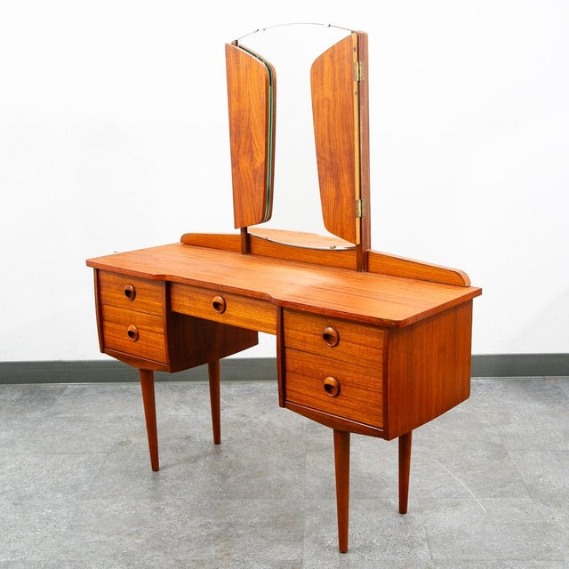 Danish modern vanity / 5 drawer chest now available. The mirror is adjustable and has 3 sections that can fold up or open...