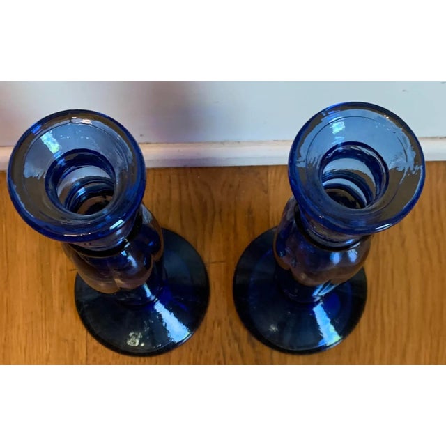 A set of 2 1990s Vintage blue glass candlesticks in the shape of spanish colonial design.