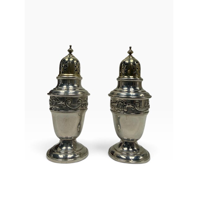 A highly elegant, complete pair of solid sterling silver salt and pepper shakers (muffineers) by the legendary American...