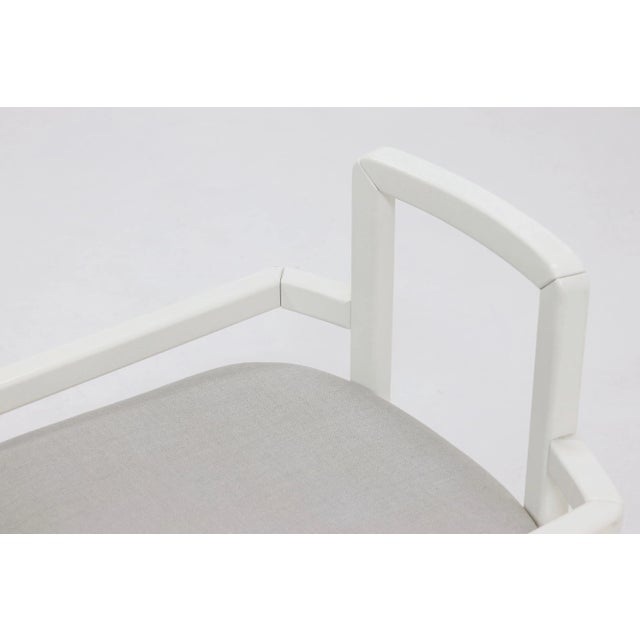 Side chair from the 1980s. The chair has an almost architectural frame and is made of white lacquered wood with a light...
