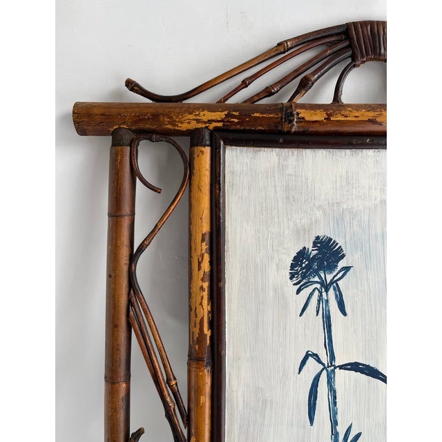 A single rectangular hand painted chinoiserie panel featuring a blue and white pot with stylized bamboo. Finished with a...