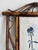 A single rectangular hand painted chinoiserie panel featuring a blue and white pot with stylized bamboo. Finished with a...