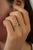 This dainty ring features a 0.5 carat oval-cut emerald set in 14K yellow gold. The emerald measuring 4 x 5.8 mm, elegantly...