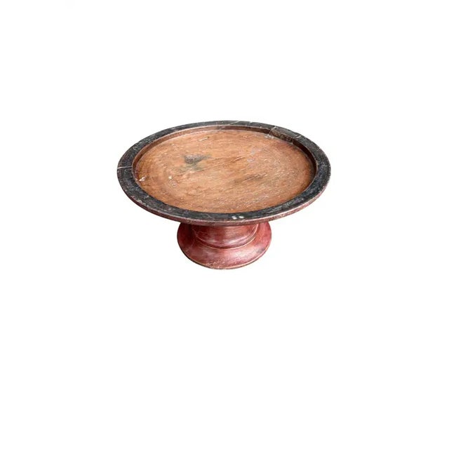 A vintage Balinese dulang offering tray featuring a deep red lacquer finish softened by time. The surface shows gentle...