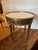 Very pretty round medium sized end table having white marble top with pierced brass gallery. The polished mahogany has...