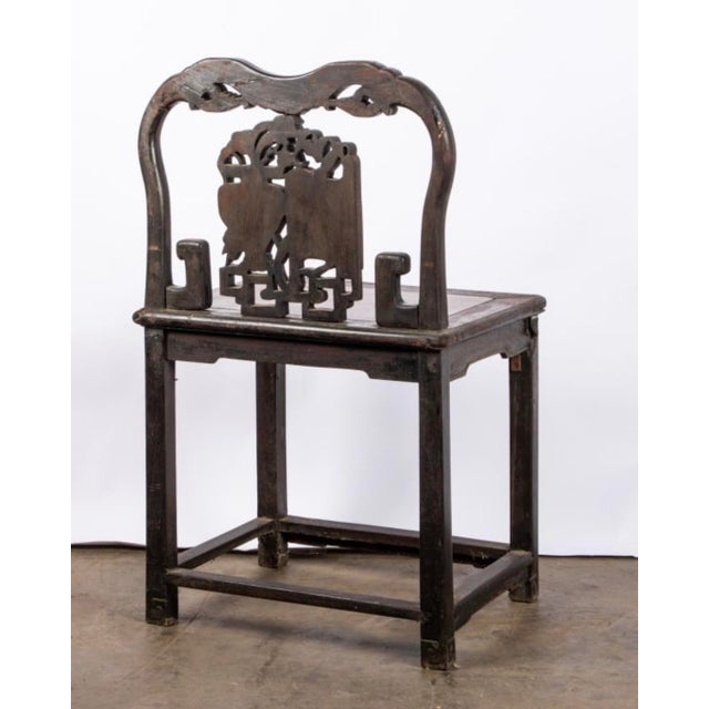 Beautiful 19th century Chinese carved hardwood hall chair featuring a marble inset seat, twin marble inset back panels,...