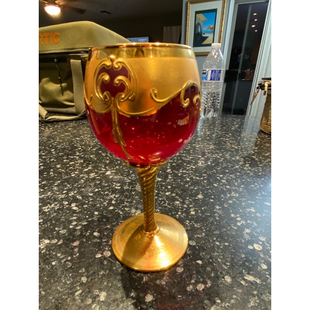 Set of four mid-century Venetian / Murano-style art glass goblets featuring ruby red bowls with matte gold wash, raised...