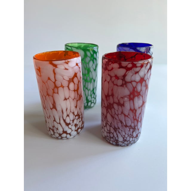 Set of four colorful handblown confetti glasses, one orange, one red, one blue and one green. Combined shipping available.