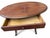 Charming antique oval occasional table featuring an expressive aged wood surface, a single functional drawer, and an...