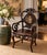 A striking vintage Chinese armchair crafted in a richly toned dark hardwood and extensively decorated with mother-of-pearl...