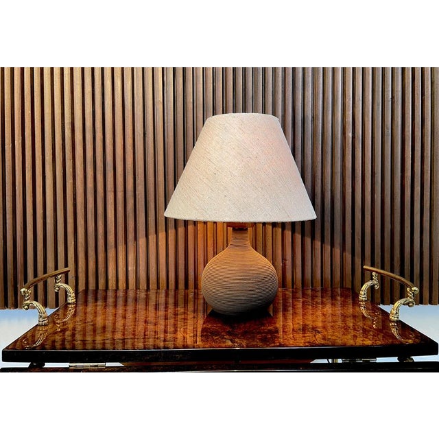 This high-quality table lamp was hand-crafted in Germany during the 1950s. Its vase-shaped ceramic base features fine...