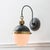 Styled in a classic hanging formation with multiple finishes to choose from, this sconce merges 20th century design with...