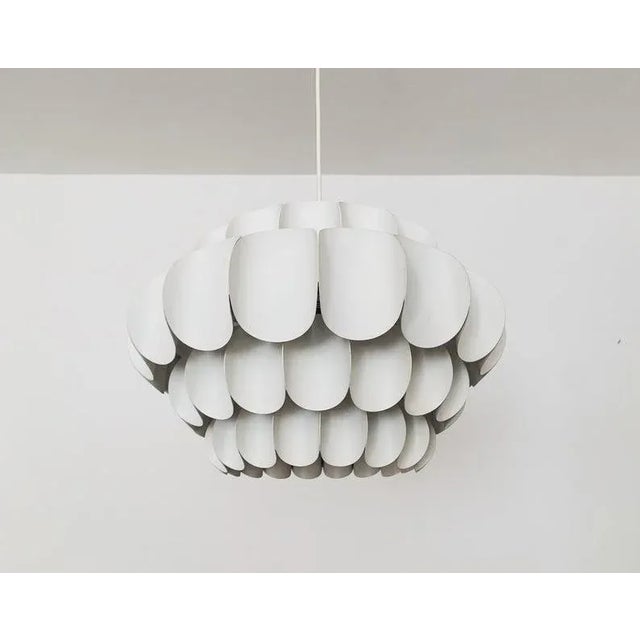 Wonderful white metal pendant lamp by Thorsten Orrling from the 1960s. The extraordinary design creates a fantastic play...