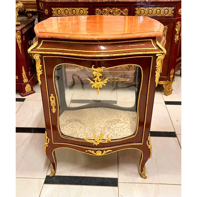 Bring timeless French elegance into your home with this exquisite French Louis XV Curio Display Cabinet, masterfully...