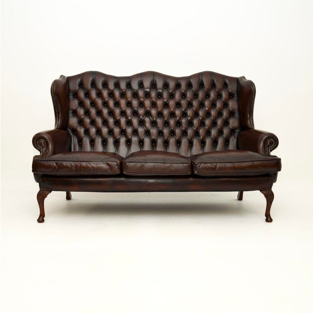 A superb antique leather wing back sofa. This was made in England, it dates from around the 1930’s. The quality is superb...