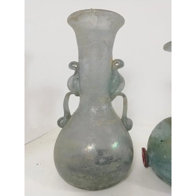 Set of four hand -worked vases in ancient Roman style. The processing in question takes the name of excavation. Just to...