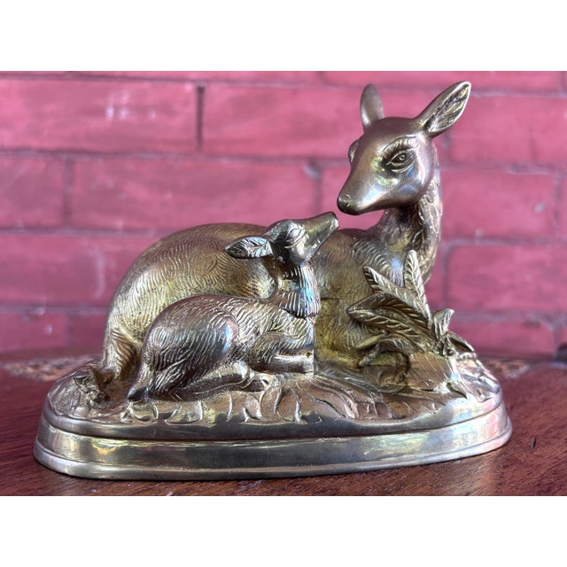 This is a charming vintage hollow-cast brass sculpture depicting a mother doe resting with her affectionate fawn. Features...