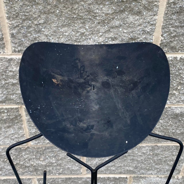 A unique vintage postmodern style stick figure floor standing candle stand in welded wrought iron.