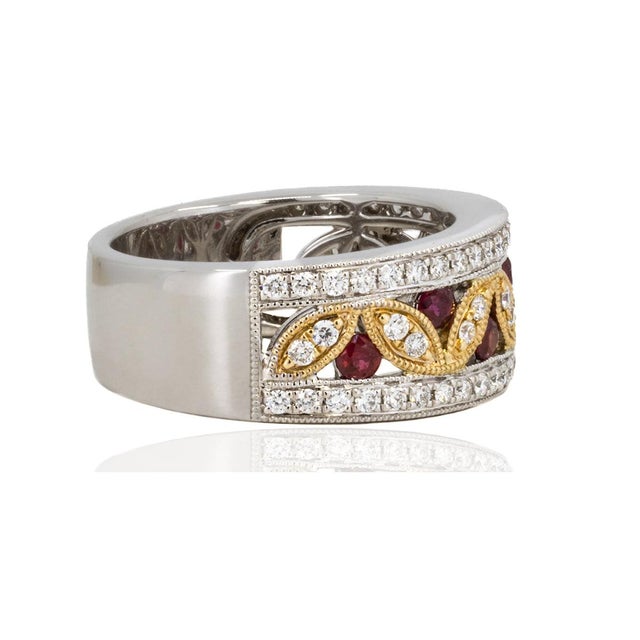 This 14k white and rose gold ring features 7 rubies weighing 0.58 carats and 66 round diamonds weighing 0.61 carats,...
