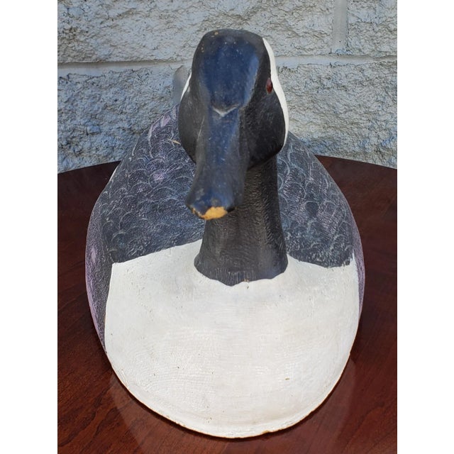 An Mid Century, large, Hand-crafted and Hand-Painted Hardwood American life size Duck Decoy measuring 21" in width, 9" in...