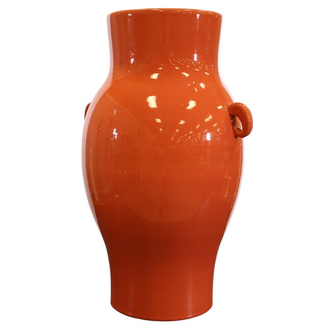 A large baluster vase in a coral glaze with two handles by Bitossi Italy.