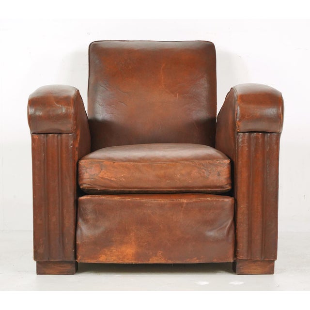 Vintage tank style Art Deco dark brown leather studded club chairs made in France. It has a square backrest, thick rolled...
