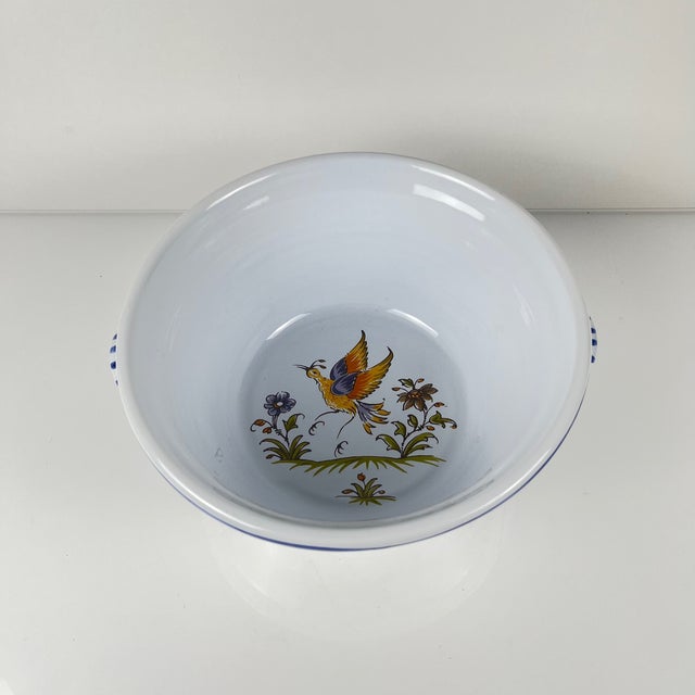 Large hand-painted earthenware salad bowl, signed “Mousiter” on the reverse, 20th century Floral and animal motif in...