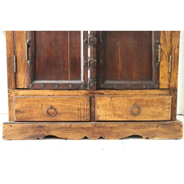 The large antique primitive wooden armoire or cupboard is a stunning piece of vintage furniture from the early 1900s....