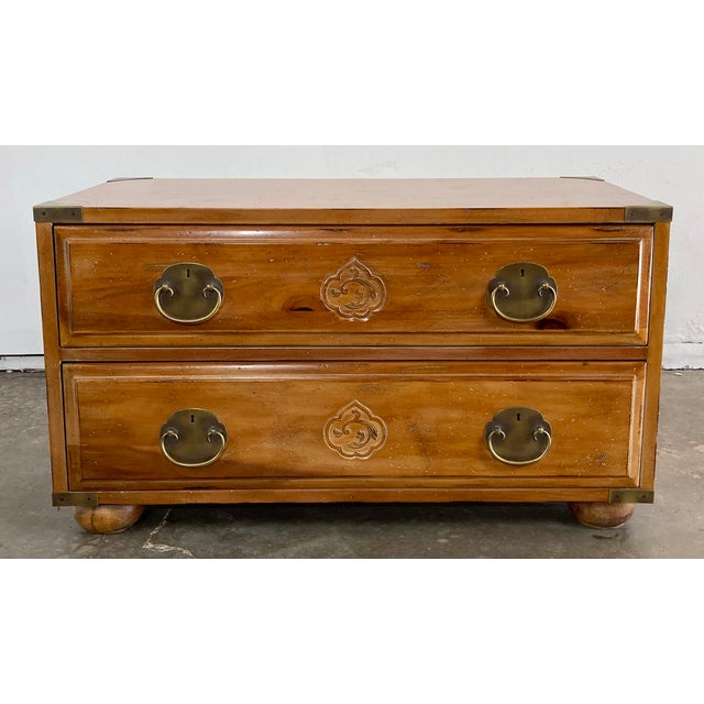 Vintage Henredon footed campaign two (2) drawer pine chest. Features carved Asian motif medallions to drawer fronts with...