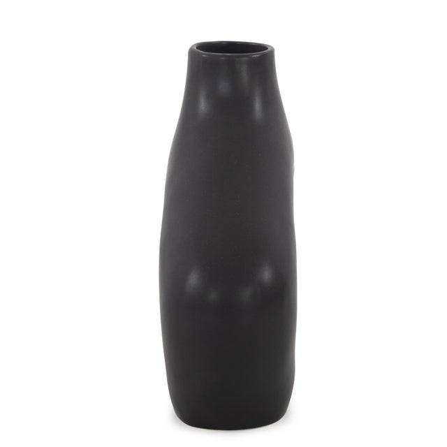 This vase breaks away from convention with its striking irregular shape, challenging traditional forms with a bold and...