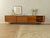 A unique sideboard from the 1960s. Its walnut veneer body features three drawers, four doors, two shelves, and new...