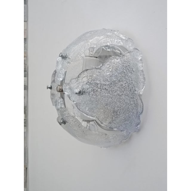 Magnificent ice glass wall sconce. Italy, 1970s. Chrome-plated metal frame. It supports beautiful Murano glass diffusers,...