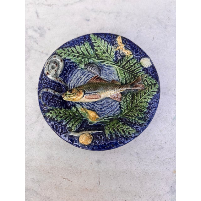 Small 19th Century round Palissy fish platter Thomas Sergent. decorated with a fish on the center ,on the border a snail,...
