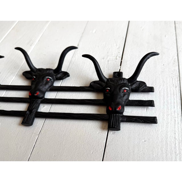 Vintage western rockabilly painted black and red iron long horn bull coat or hat rack. Meant for the wall. In excellent...