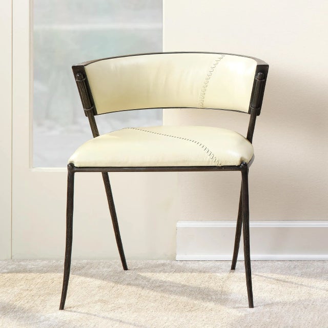 Off-white leather contrasts boldly with hand-forged iron in the artisan-crafted Nevado chair. Featuring a generously...