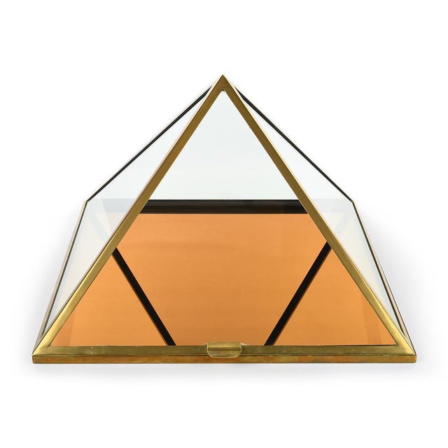 Pyramid Showcase Cabinet in Brass, in Good conditions. Designed 1920 to 1949 This piece is designed in the style of the...
