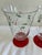 Vintage set of two Pfaltzgraff holiday glasses featuring classic holly berry decoration and striking red stems. These...