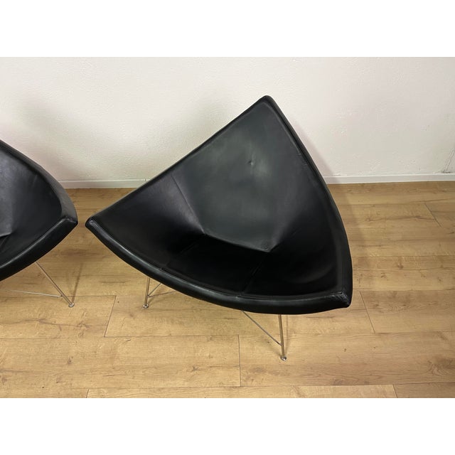 Pair of armchairs with a steel base, fiberglass shell, and leather upholstery, designed by George Nelson for Vitra in the...