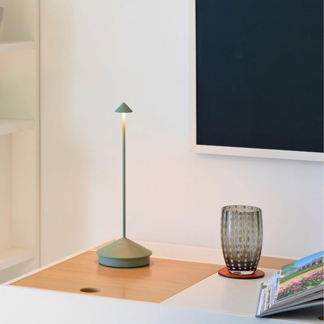 Pina Pro Battery-operated and rechargeable portable table lamp. The lamp features dimming touch control and has 3-CCT...