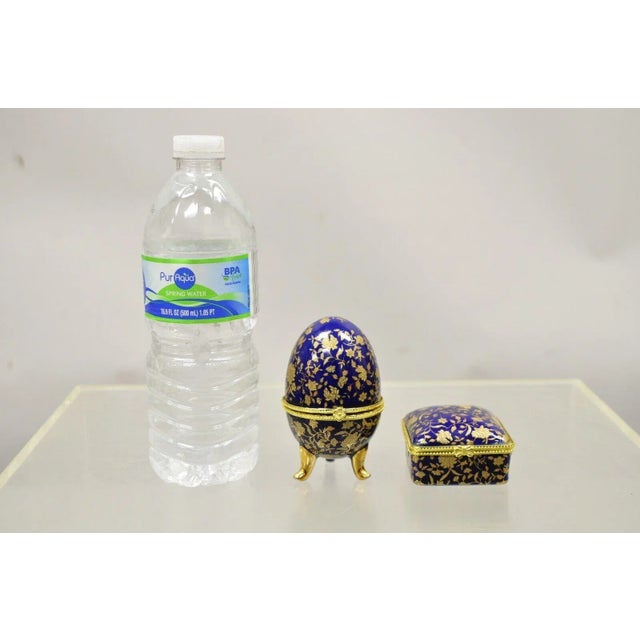 Cobalt Blue Porcelain Egg Gold Gilt Hinged Lid Candle Trinket Box - 2 Pcs. Item featurs a porcelain construction, gold...