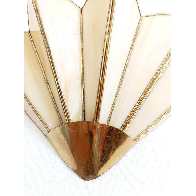 Art Deco wall sconce in a fan shape. Palmettes in marbled beige glass paste and a gilt metal frame. Provides a beautiful,...