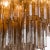 Four tiers of fluted glass tubes create this beautiful mid-century inspired dining chandelier. The textured glass tubes...