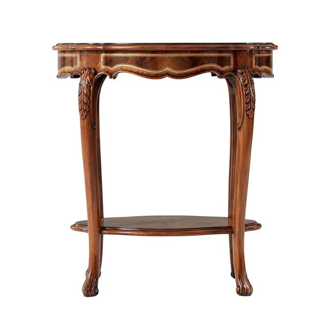 A figured walnut and mahogany banded accent table with inlaid and crossbanded details, the serpentine molded edge oval top...