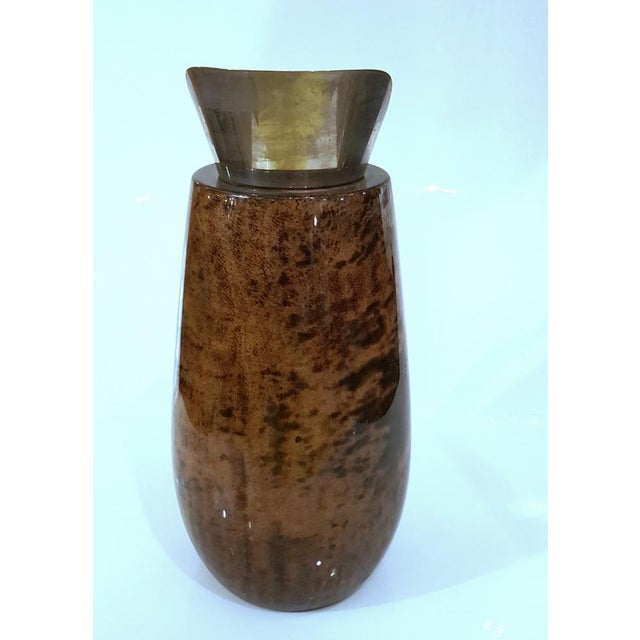 Elegant shape, amazing patterning and color variations of the goatskin leather. This piece is attributed to the mentioned...