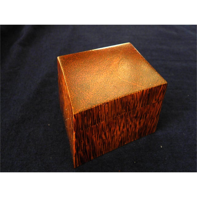 Both the body and lid of this jewelry -- or trinket -- box has been hollowed out of the same block of coconut palm wood so...