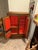 A wooden cabinet featuring three hinged doors and nickel-plated brass hardware, showcasing prominent wood grain and a...