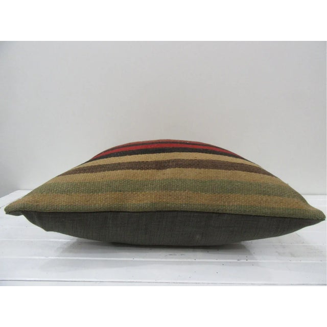 This is a pillow cover made from a vintage kilim rug. The piece was properly washed and ready to use. Pillow inserts not...